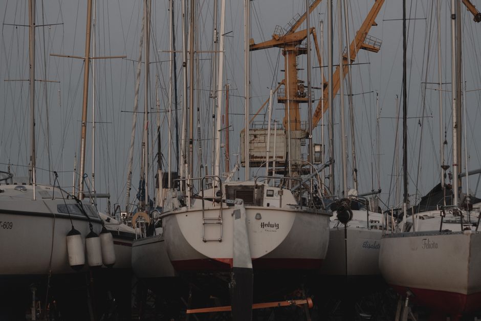 Sailboats hauled out in a boatyard at dusk