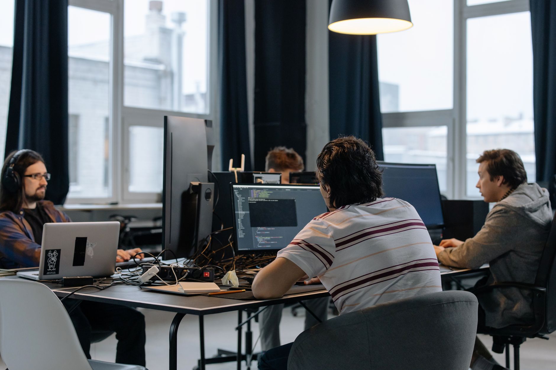 Software team working at laptops