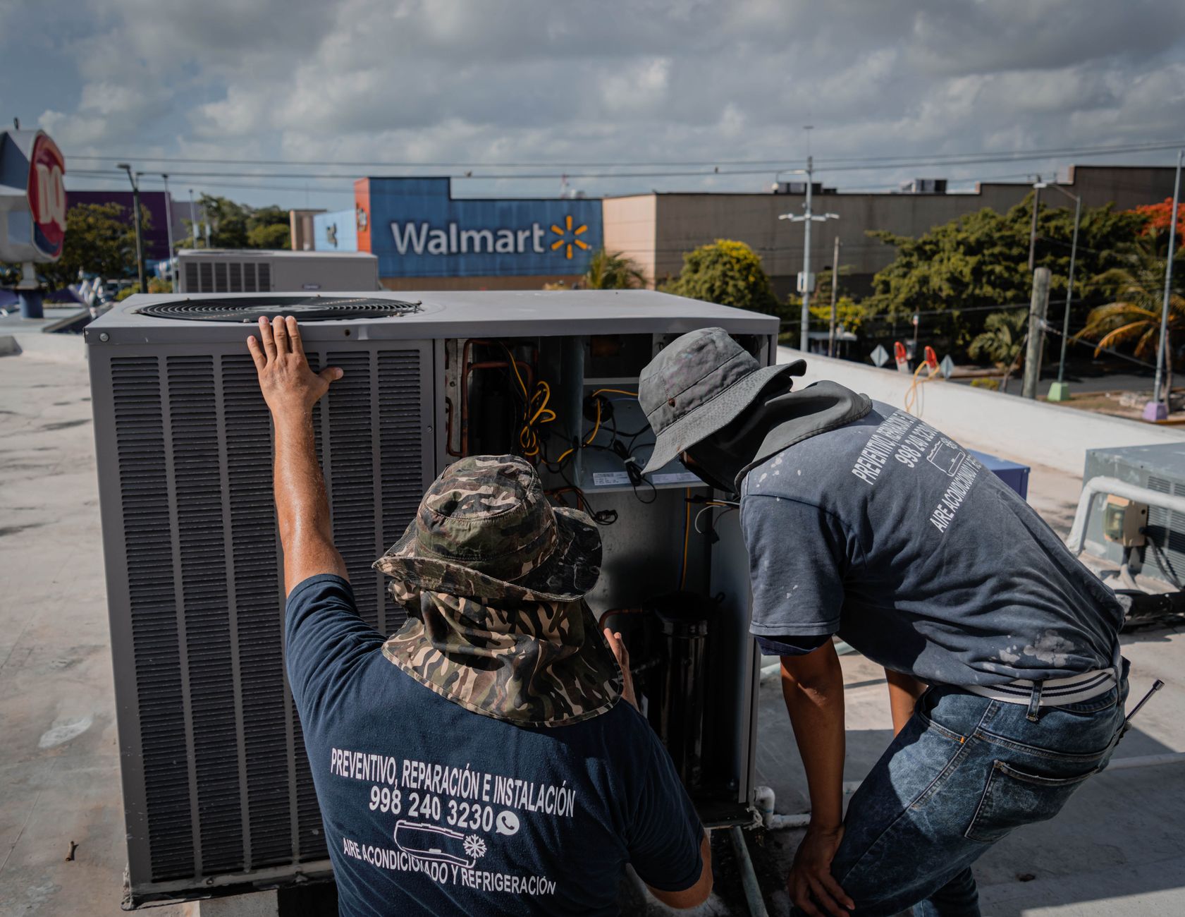 HVAC technician servicing a rooftop unit