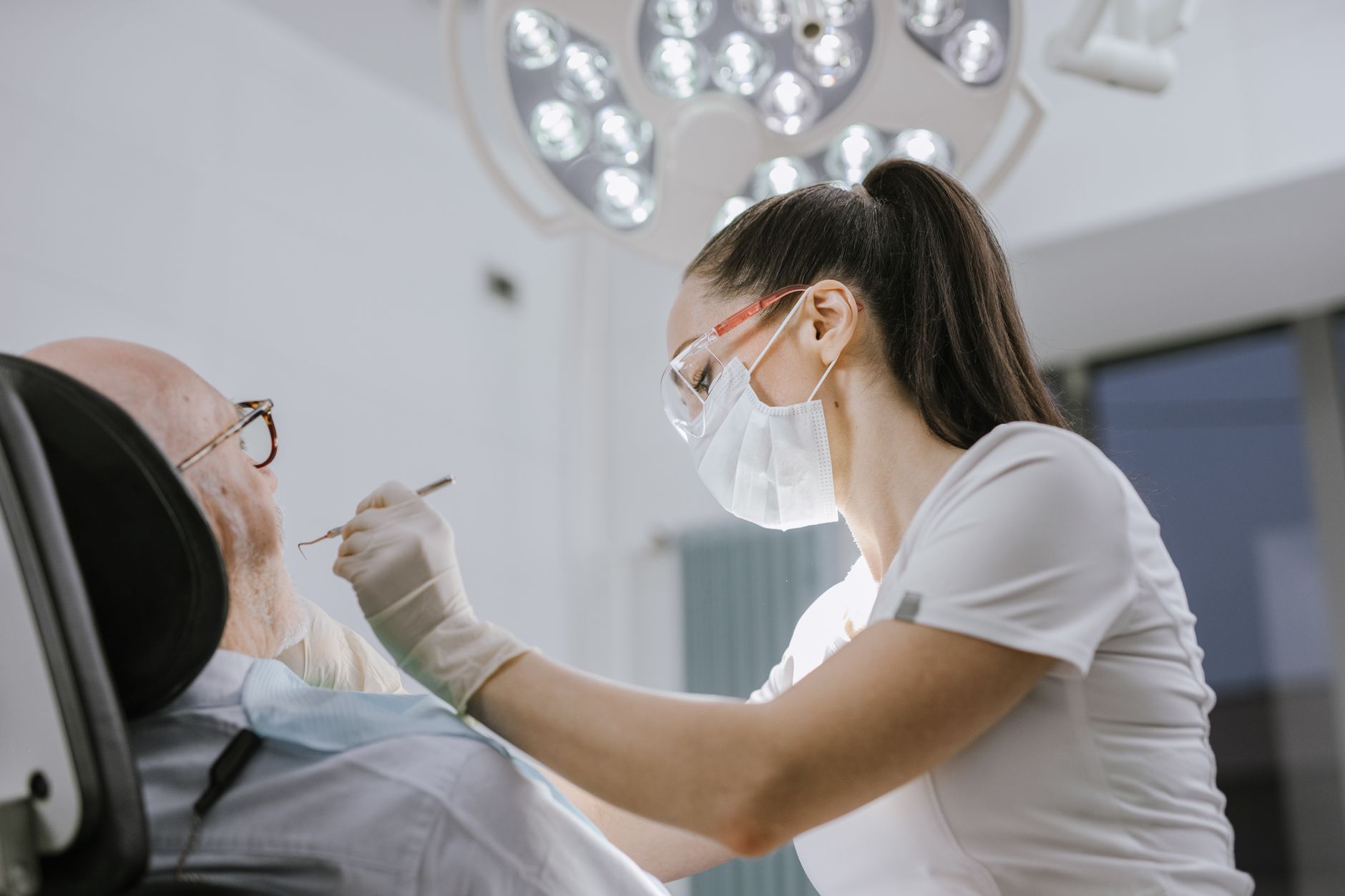 Dentist treating a patient in the chair
