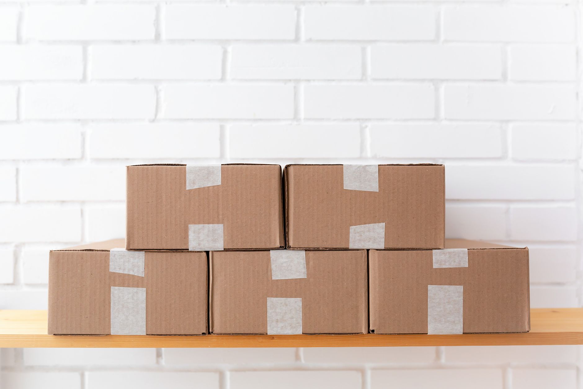 Stacked cardboard shipping boxes on a warehouse shelf