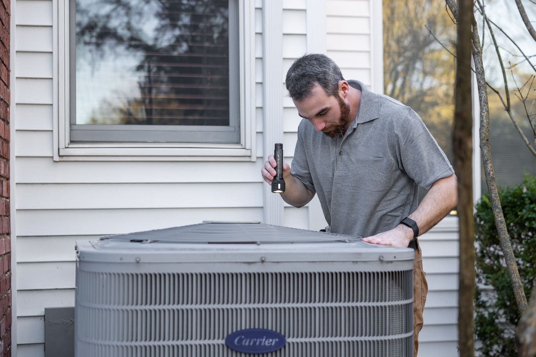 HVAC technician servicing an outdoor unit