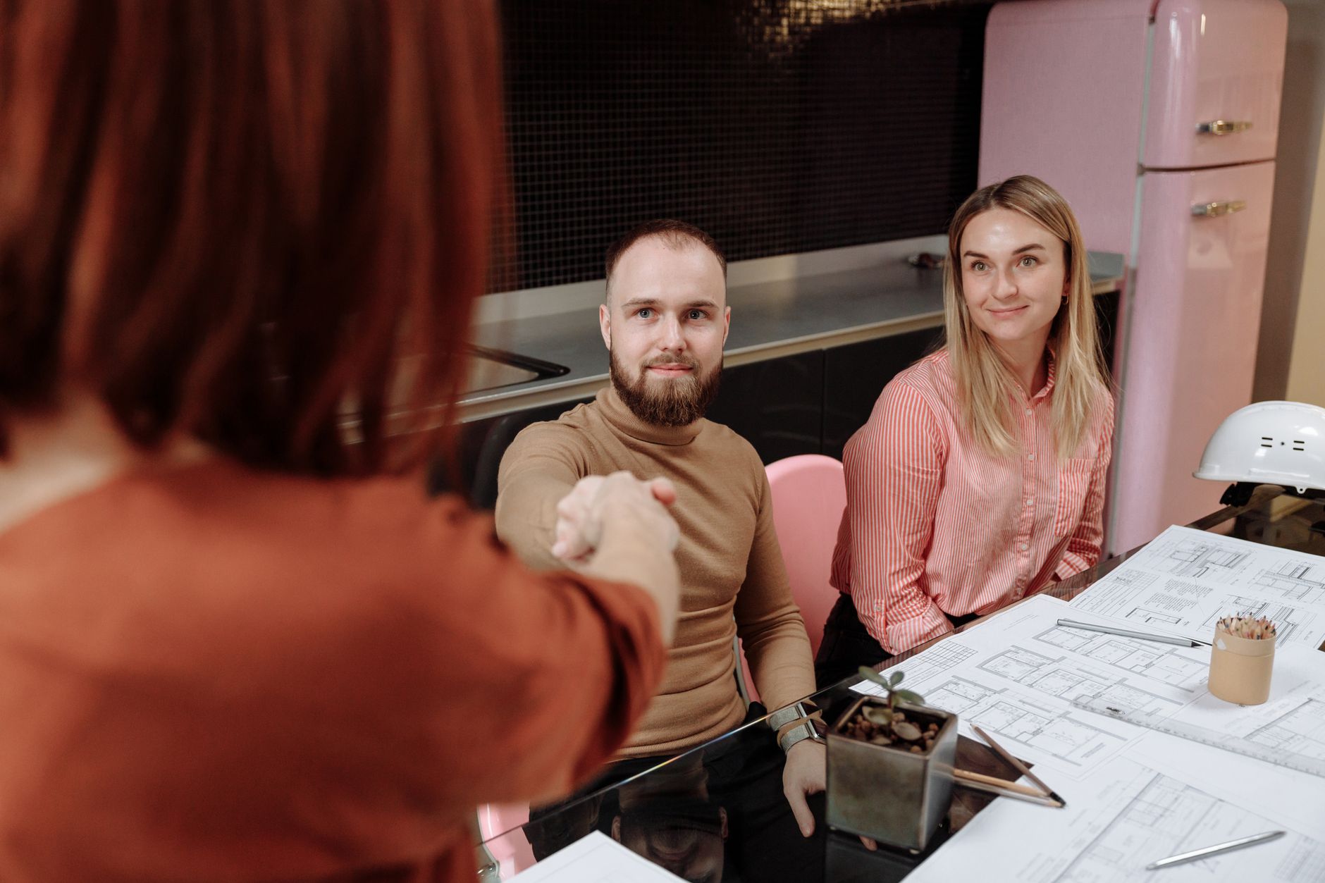 Business professionals sealing an agreement with a handshake at a table