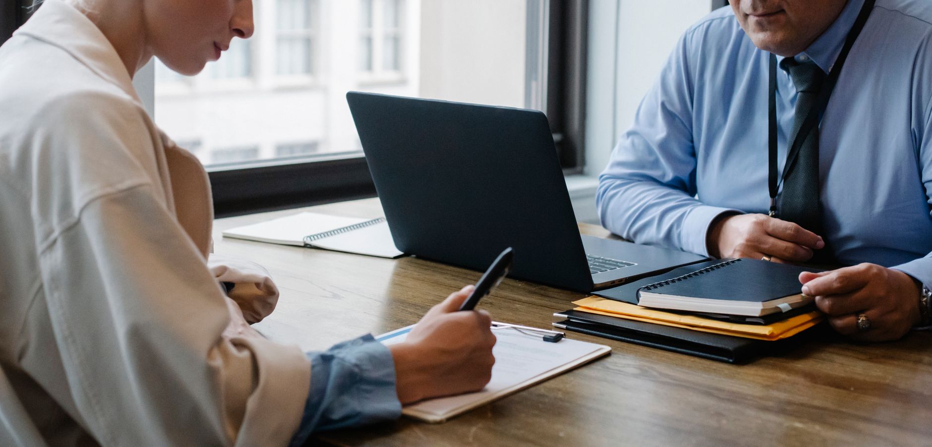 Business partners signing a contract at an office table