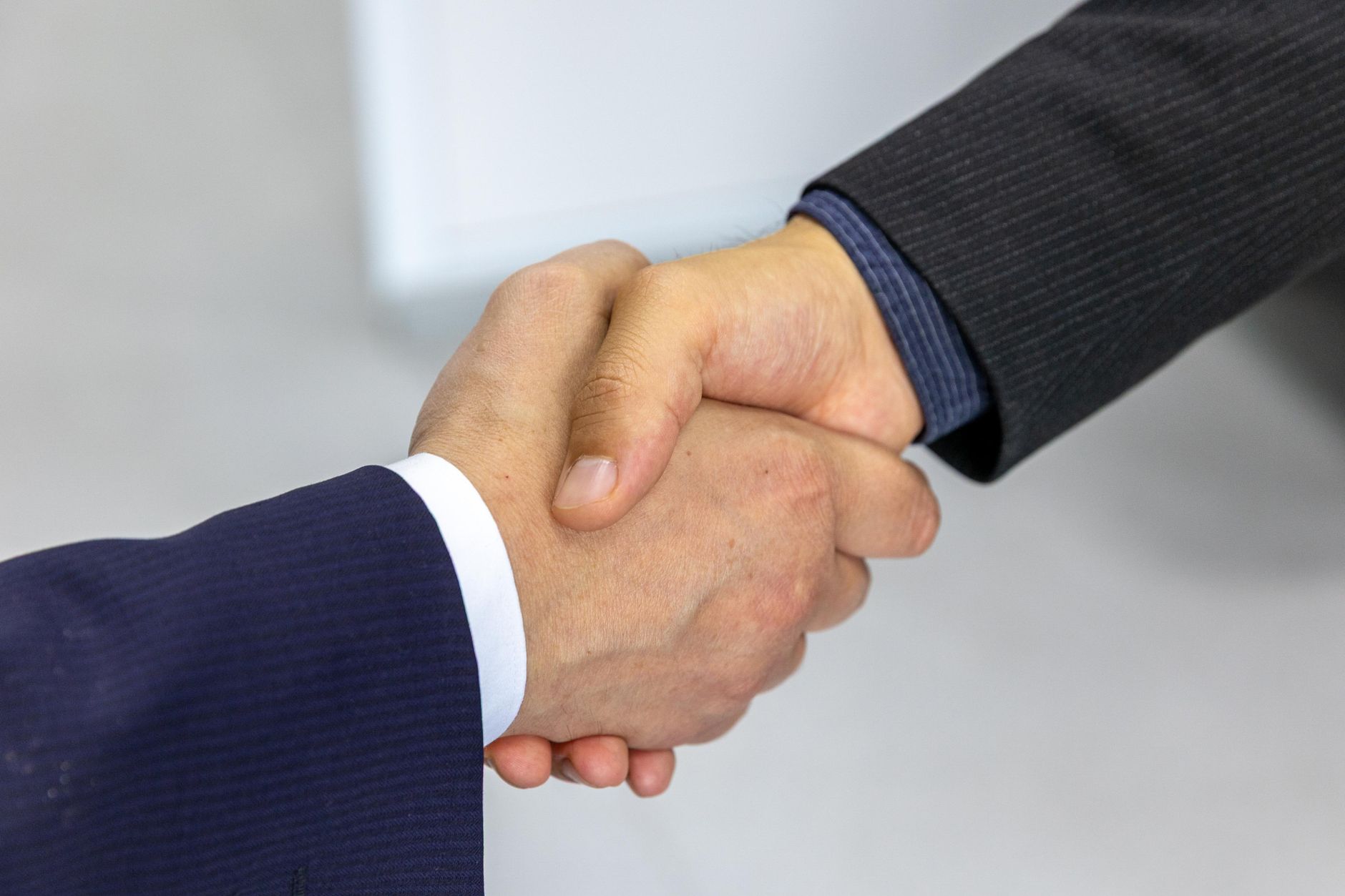 Two businesspeople shaking hands to signal agreement