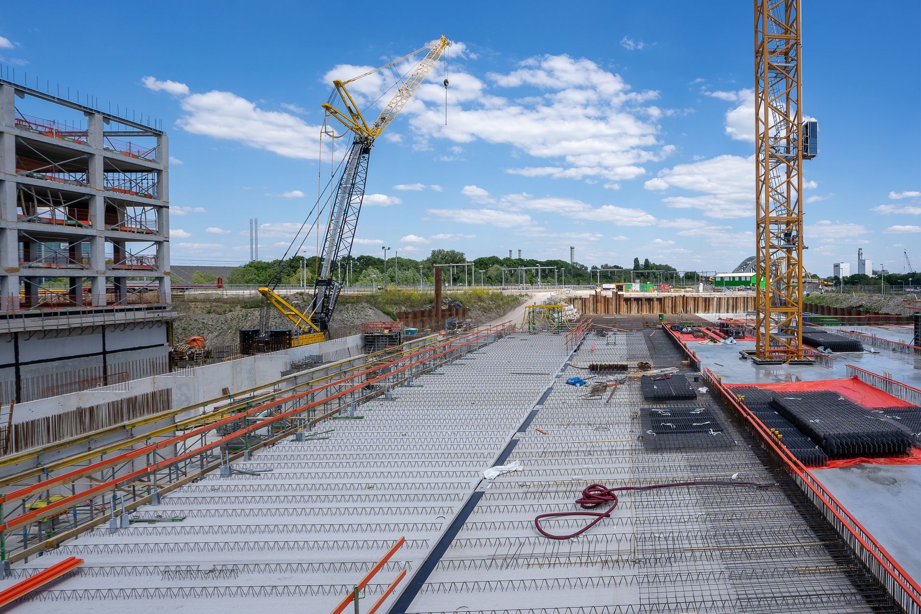 Busy construction site with cranes and a building under construction