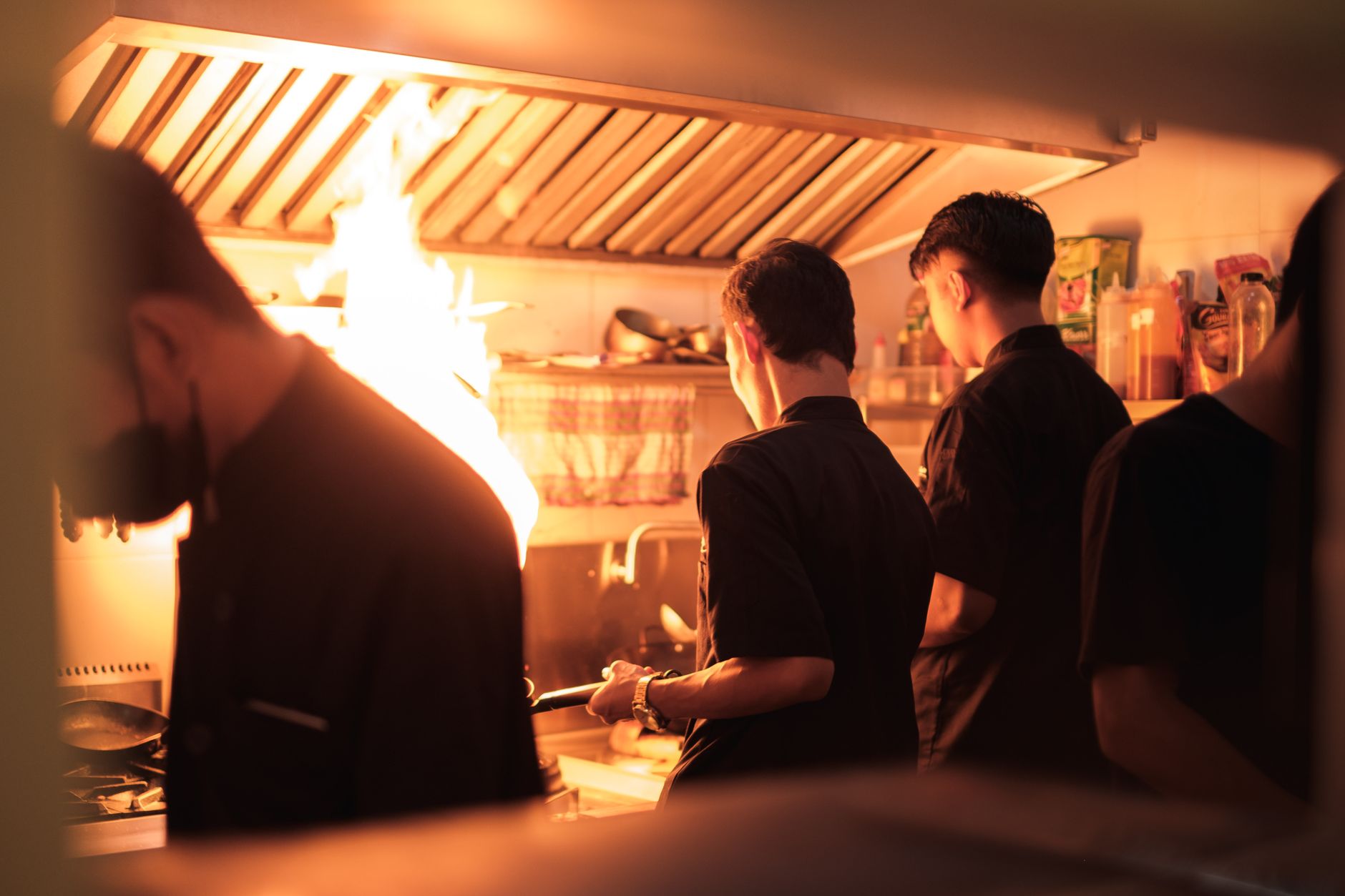 Professional chefs cooking in a busy commercial kitchen