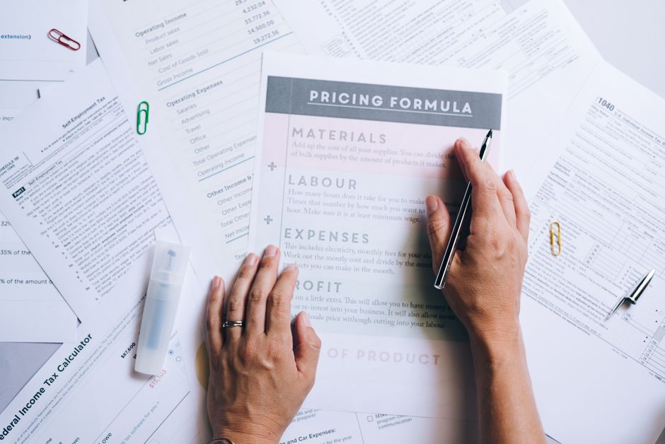 Hands organizing financial documents on a desk