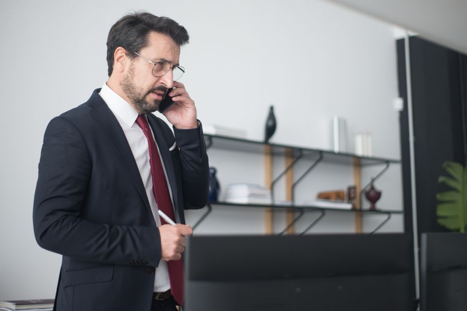 A business owner taking a call at their desk